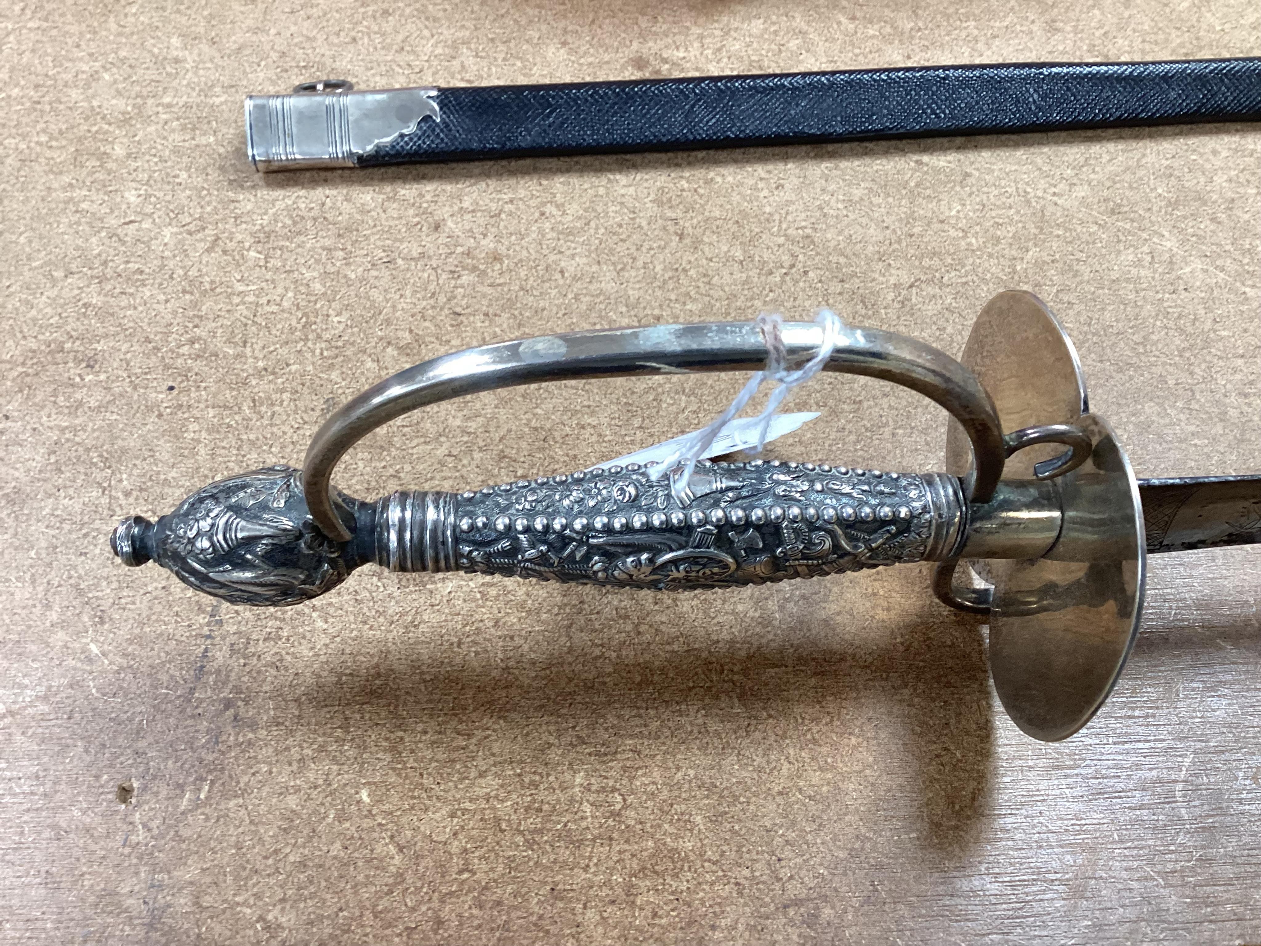 A late 18th century court sword with white metal grip, knuckle guard and mounts, decoration to scabbard band believe to be based on Admiral Duncan’s crest (Camperdown 1797), blade 84cm. Condition - fair to good, some wea